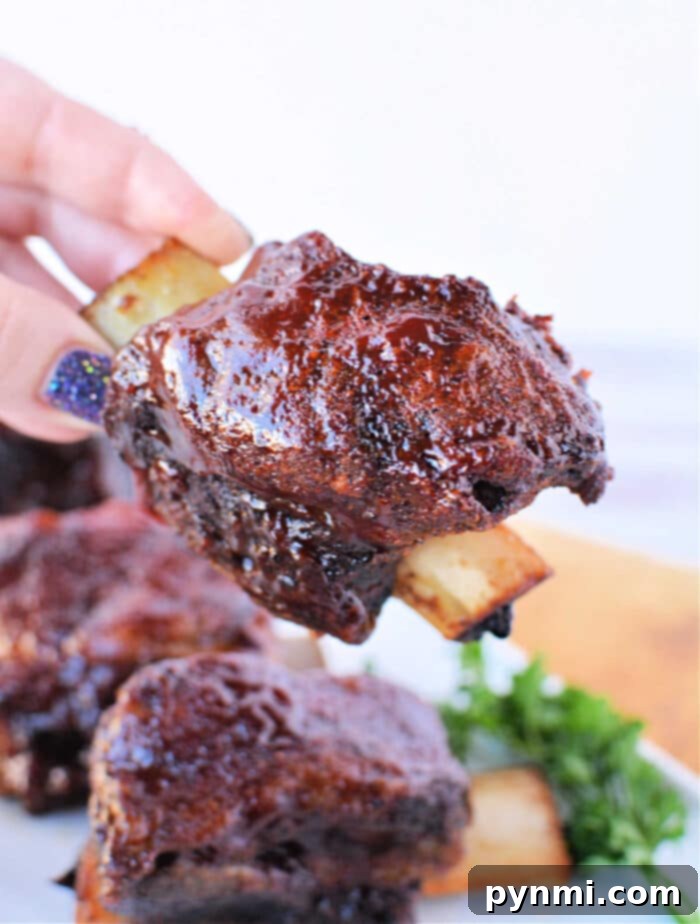 Fall-Off-The-Bone Oven Beef Ribs 8 Beef Ribs in Oven, beautifully cooked and sauced.