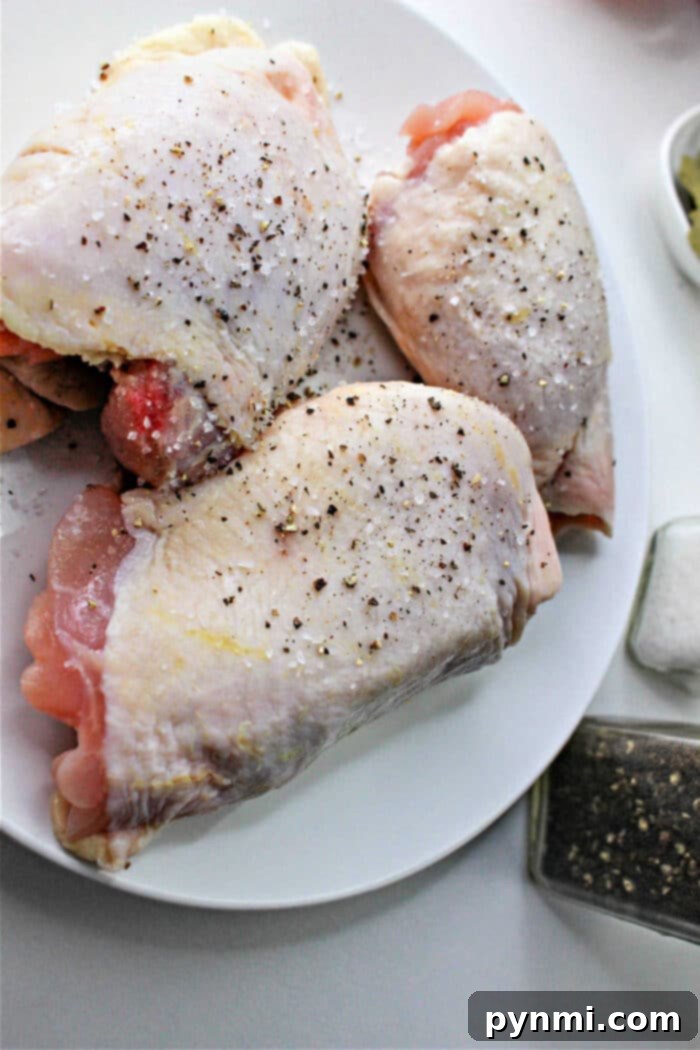 Zesty Braised Chicken Thighs 4 A Dutch oven filled with spicy braised chicken and vegetables, bubbling with rich sauce.