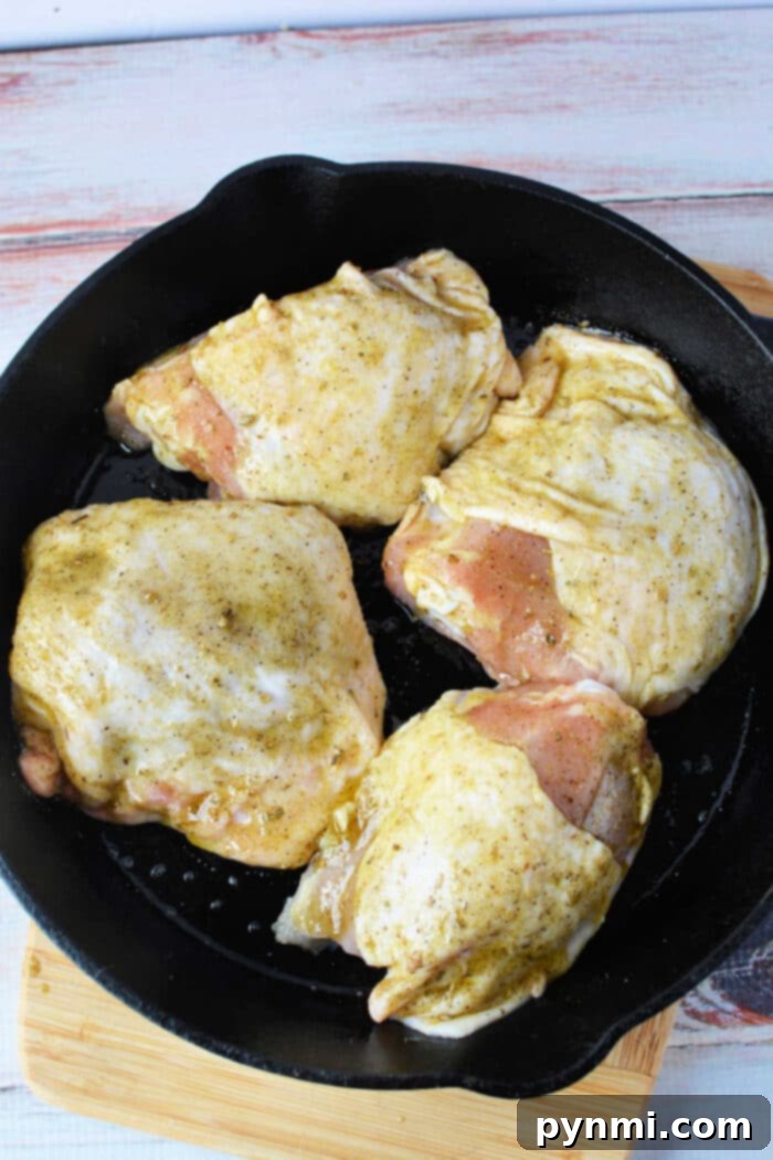 Crispy Skinned, Juicy Bone-In Chicken Thighs 8 A close-up of beautifully oven-baked bone-in chicken thighs, showcasing crispy skin and tender meat.