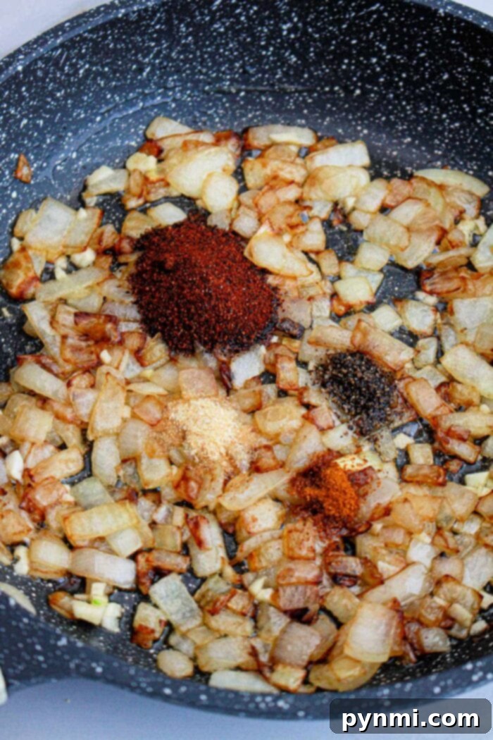 Crafting Popeyes Iconic Sauce 5 A bowl of rich, dark homemade barbecue sauce, ready for serving, surrounded by fresh herbs