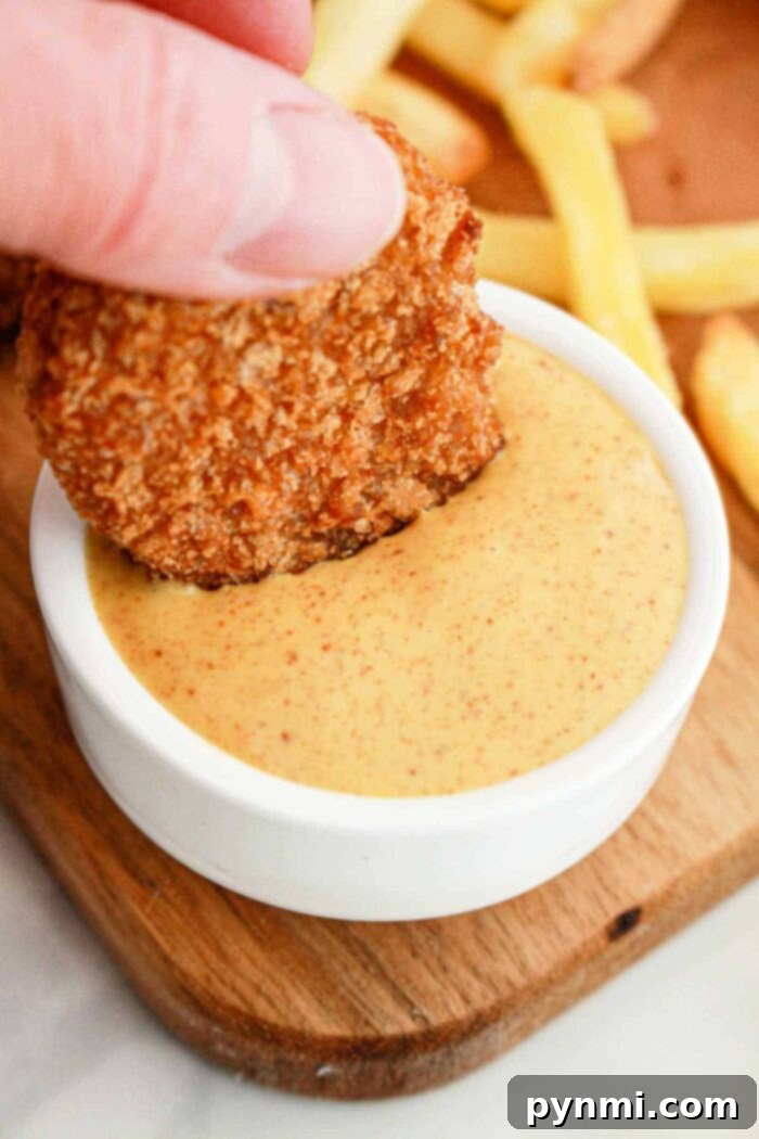 Burger King Honey Mustard Sauce in a bowl with chicken nuggets and fries