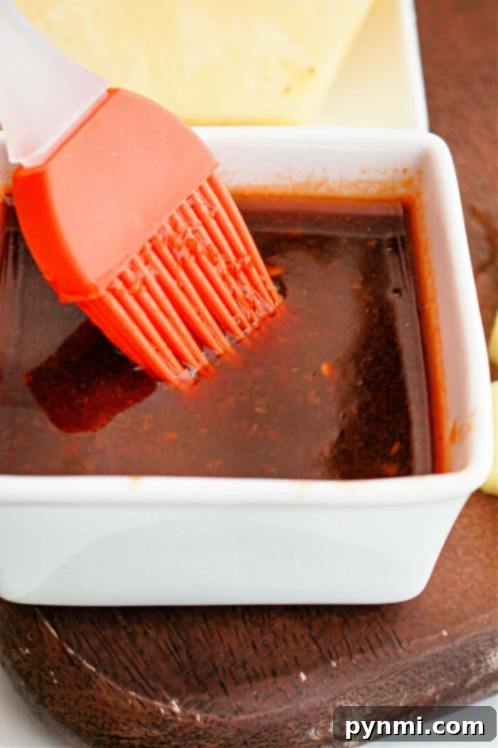 Huli Huli Sauce in a bowl with a basting brush