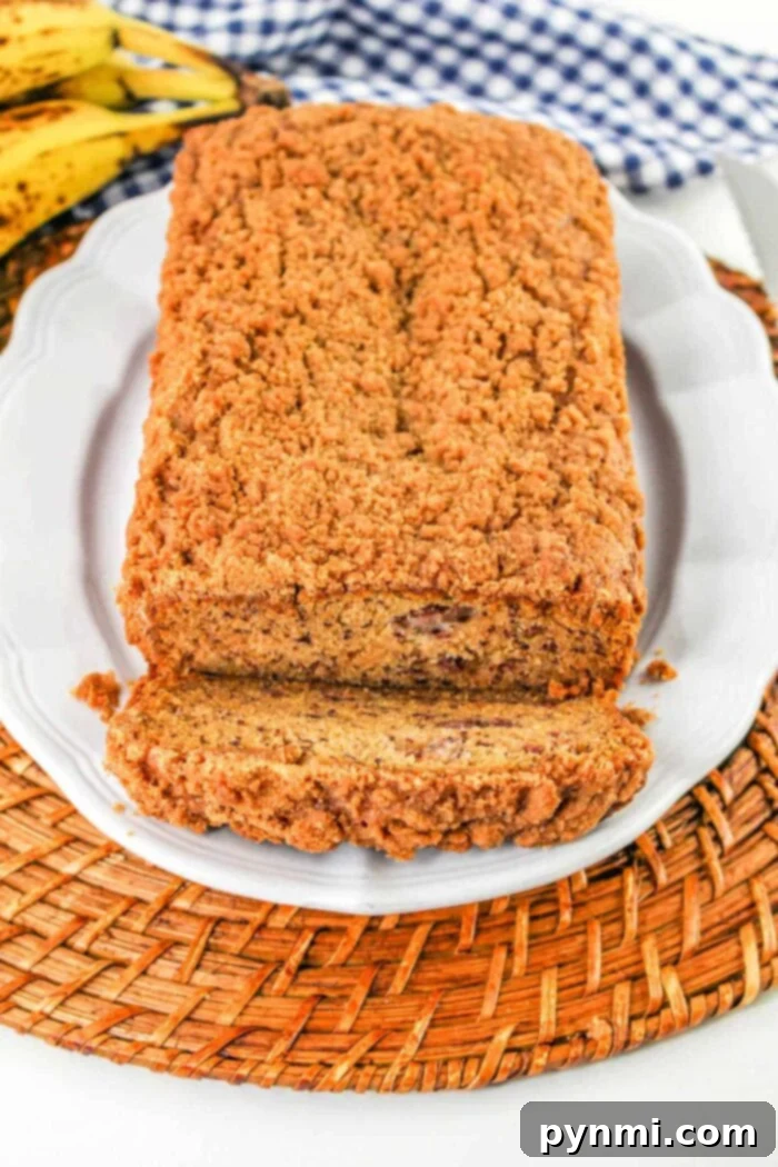 Aromatic Banana Spice Bread 2 Delicious loaf of Cinnamon Banana Bread with Streusel Topping, ready to be sliced