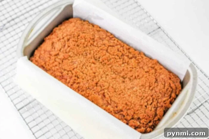 Aromatic Banana Spice Bread 5 Freshly baked cinnamon banana bread loaf cooling on a wire rack, ready to be enjoyed
