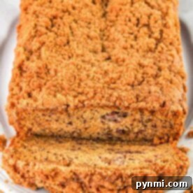 Close-up of a loaf of cinnamon banana bread with crunchy topping