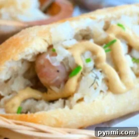 Close-up of a bratwurst in a bun topped with sauerkraut, mustard, and chives on a woven basket. As you savor this delight, ponder how long to boil brats for that perfect juiciness before grilling.