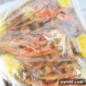 Seafood Packet Perfection 9 Learn how to cook seafood in a bag with our easy guide. This seafood boil, presented on a tray, features succulent shellfish elegantly combined with corn and spices—all sealed within a plastic bag to enhance flavor.