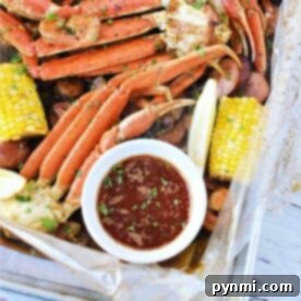 Savor the ultimate seafood boil featuring crab legs, corn, and sausages, all enhanced by a zesty lemon wedge. Accompanied by a mouthwatering dipping sauce crafted from our special seafood boil sauce recipe, this feast is a true delight for the senses.