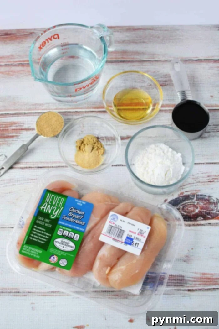 Raw chicken tenders arranged neatly, ready for boiling, illustrating the preparation stage before cooking them to perfection.