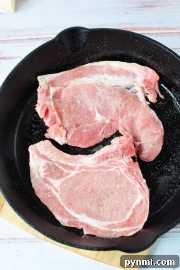 Skillet Pork Chops with Savory Mushroom Gravy 5 Hearty bone-in pork chops generously coated in a rich mushroom gravy, served hot.