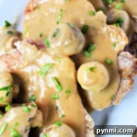 Savor the flavors of pork chops with mushroom gravy, garnished with fresh parsley for a delightful finish.