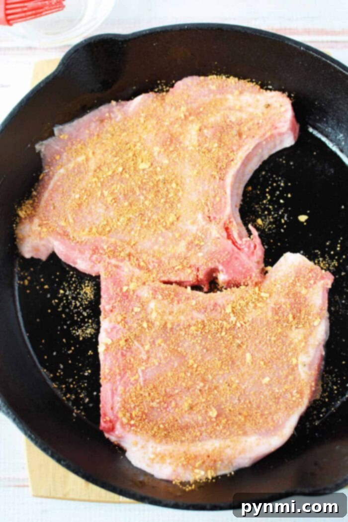 Broiled pork chops with dry rub on a cutting board