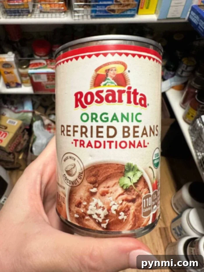 Elevate Your Canned Refried Beans 2 A beautifully garnished bowl of refried beans, illustrating how to make canned refried beans better with fresh toppings and a creamy texture.