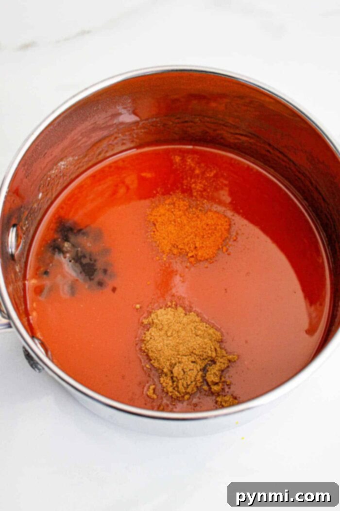 A steel pot with spices and ingredients, symbolizing the making of Popeyes Sweet Heat Sauce