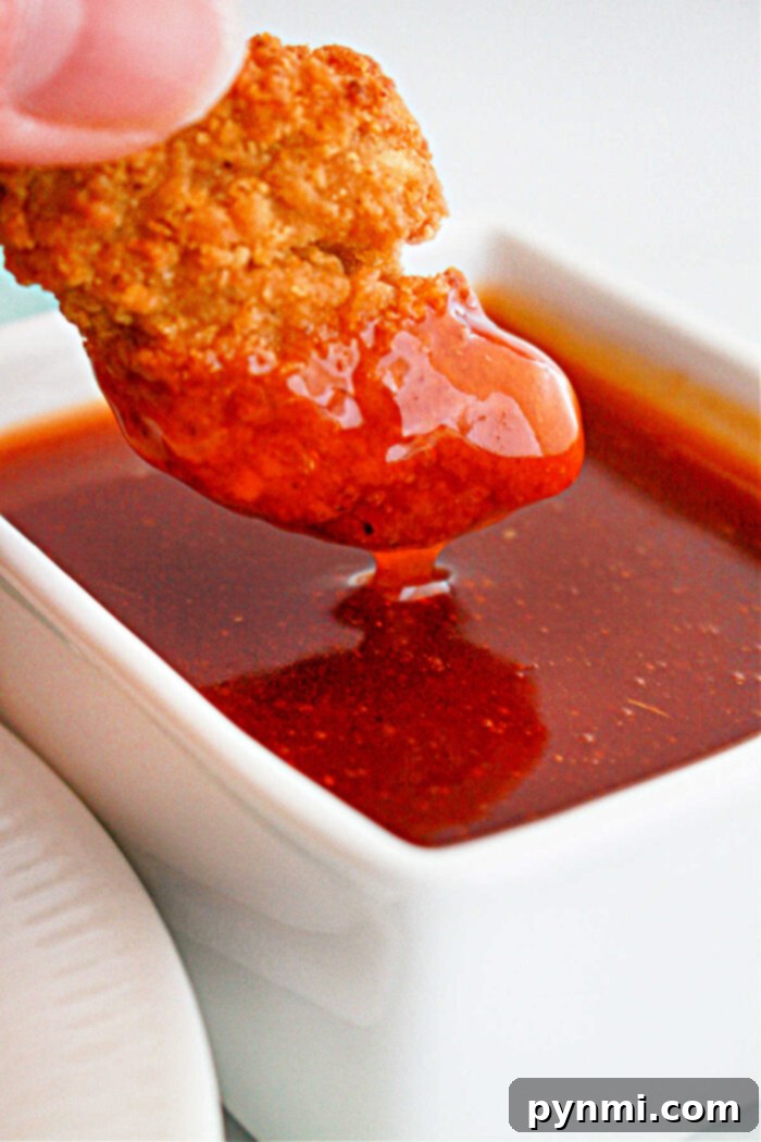 Popeyes Sweet Heat Sauce served with chicken, showcasing its deliciousness