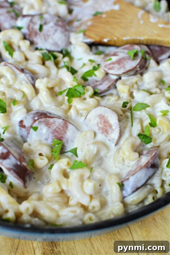 Hearty Kielbasa Pasta Skillet 2 Creamy One-Pot Kielbasa and Pasta in a skillet, garnished with fresh herbs.