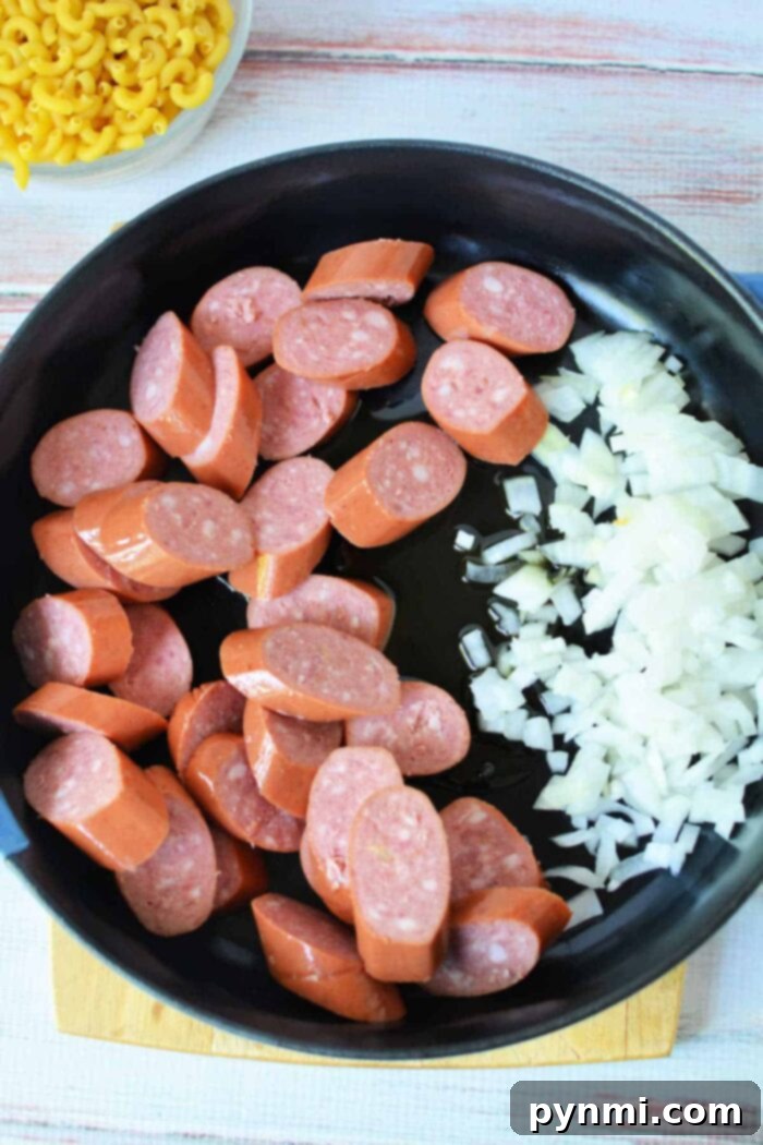 Hearty Kielbasa Pasta Skillet 3 Close-up of creamy kielbasa skillet meal with pasta and onions.