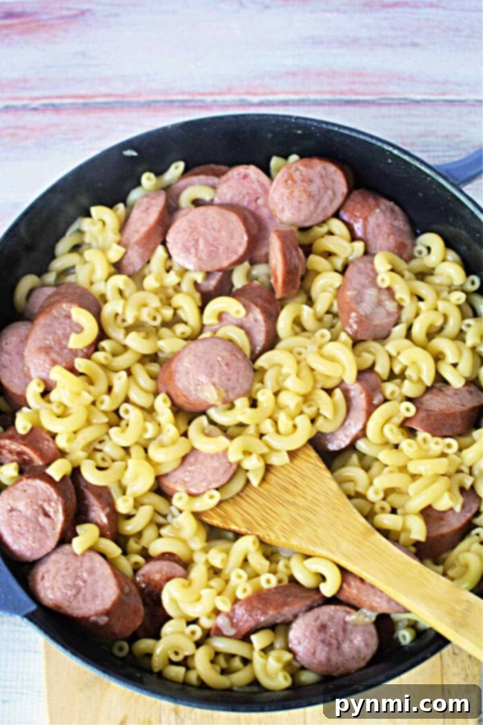 Hearty Kielbasa Pasta Skillet 7 Creamy sausage macaroni in a skillet, ready to serve.