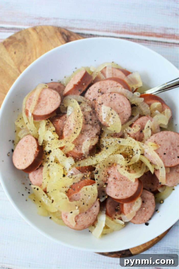 Kielbasa and onions recipe, served hot, showcasing the tender sausage and soft onions