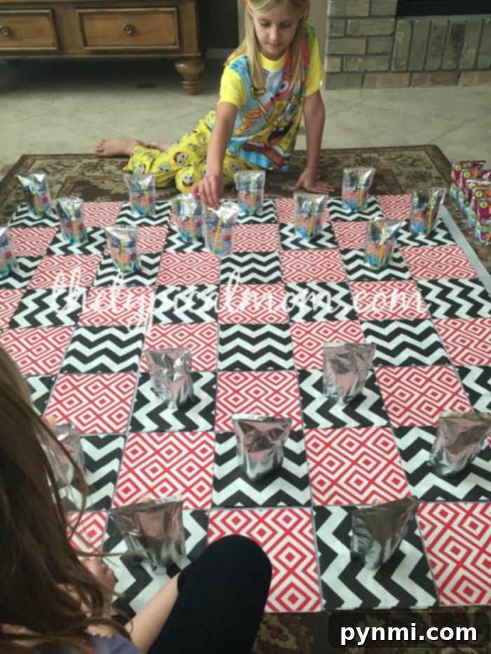 Finished Giant Checker Board: Fun Games to Play at Home with Kids Using Juice Pouches, Napkins, & a Tablecloth! The finished giant checker board with Capri Sun pouches ready for play
