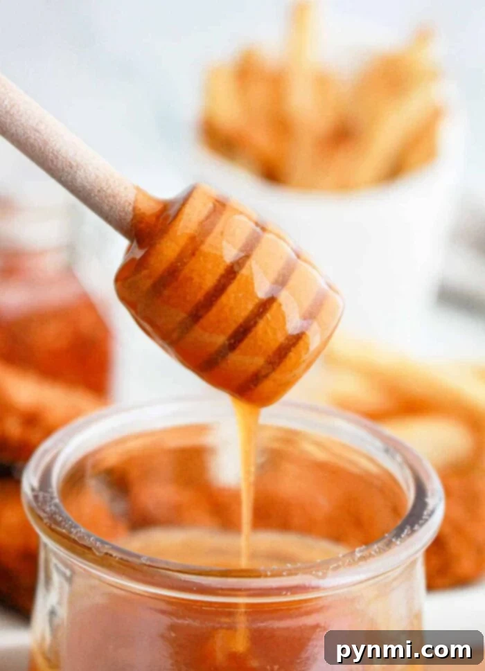 Sweet Heat Perfection: Crafting Homemade Hot Honey 2 Hot Honey Sauce drizzled generously over food, showcasing its vibrant color and luscious texture.