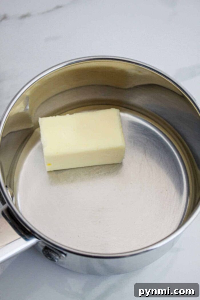 Sweet Heat Perfection: Crafting Homemade Hot Honey 4 Steps showing how to combine honey and hot sauce ingredients in a saucepan, demonstrating the easy process of making the sauce.