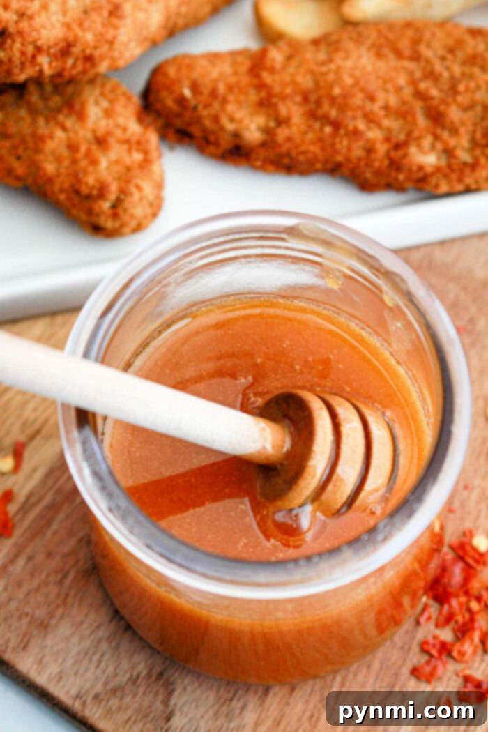Sweet Heat Perfection: Crafting Homemade Hot Honey 6 A final close-up of a jar of Copycat Mike's Hot Honey Recipe, showcasing its rich, amber color and inviting texture.