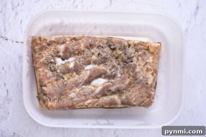 Perfectly confited pork belly, glistening with rendered fat, sliced into thick, tender pieces, ready to be enjoyed as a gourmet dish.