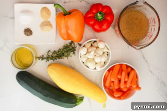 An assortment of ingredients for slow cooker vegetables are laid out on a light-colored surface. These include a yellow squash, zucchini, baby carrots, a small bowl of garlic cloves, red and orange bell peppers, fresh thyme, olive oil, seasoning mix, and a measuring cup with broth.