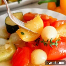 A close-up of a plate with cooked vegetables, including cherry tomatoes, onions, and slices of zucchini. A fork is picking up a piece of yellow pepper. A yellow bell pepper and more slow cooker vegetables are visible in the background.