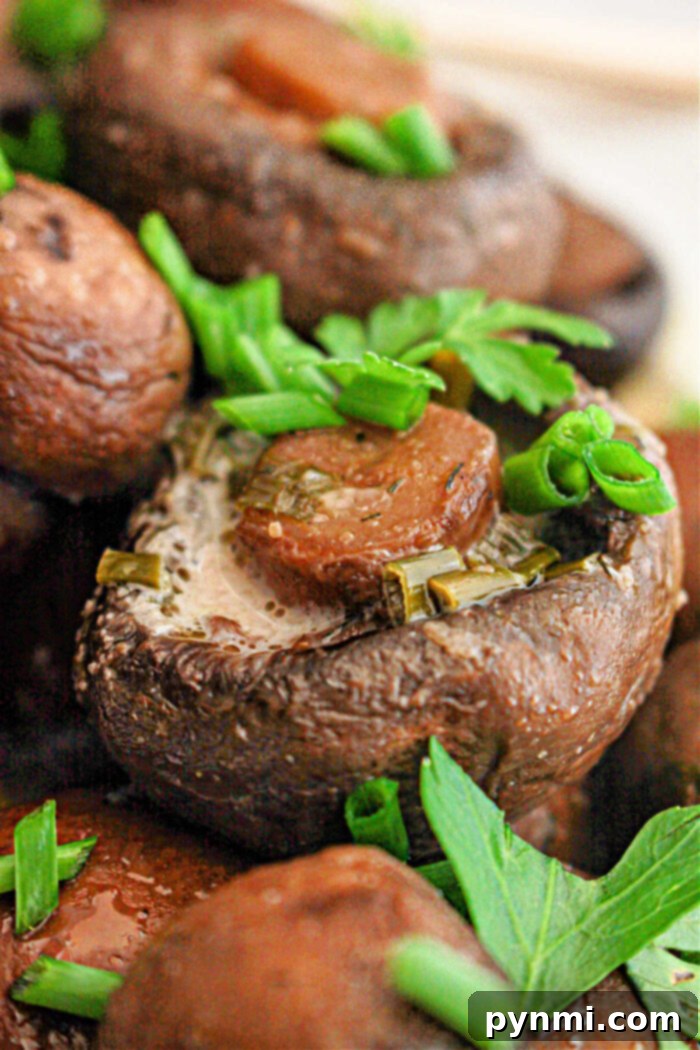 Crockpot mushrooms topped with herbs and a slice of sausage deliver a savory delight.
