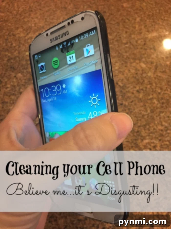 A person carefully disinfecting their cell phone with a specialized wipe, emphasizing the importance of keeping devices germ-free.