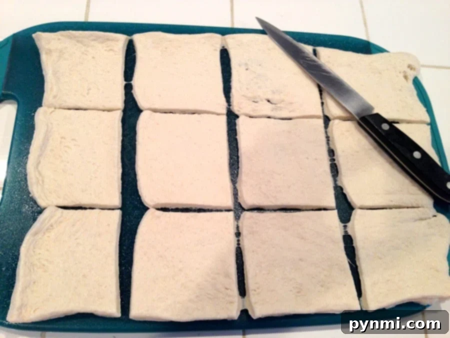Step-by-Step Muffin Tin Pizza Preparation: Dough, Sauce, Cheese, Toppings An in-progress shot demonstrating the meticulous preparation of muffin tin pizzas, where raw dough cups within a muffin tin are being carefully filled with rich pizza sauce, a generous layer of cheese, and an assortment of fresh, enticing toppings.
