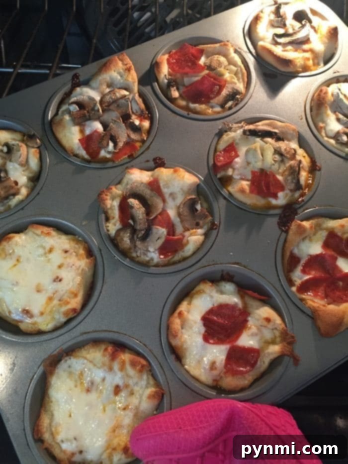 Baked Mini Muffin Tin Pizzas: Quick & Easy Family Dinner A delectable spread of four perfectly baked mini muffin tin pizzas, boasting golden-brown crusts and gooey, melted cheese, artfully arranged and ready to be served as an incredibly quick, easy, and satisfying family meal or snack.