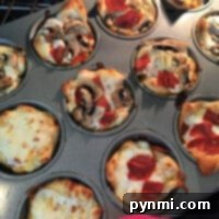 Muffin Pan Pizza Bites 2 Savor the delightful aroma of pizza muffins as mini pizzas with assorted toppings like pepperoni and mushrooms bake to perfection in a muffin tin.
