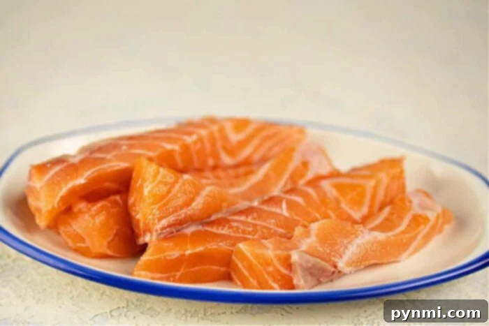 Crispy Floured Salmon 3 Salmon fillet strips prepared for frying, showing the skin side down