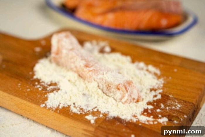 Crispy Floured Salmon 4 Salmon pieces coated in seasoned flour, ready for frying