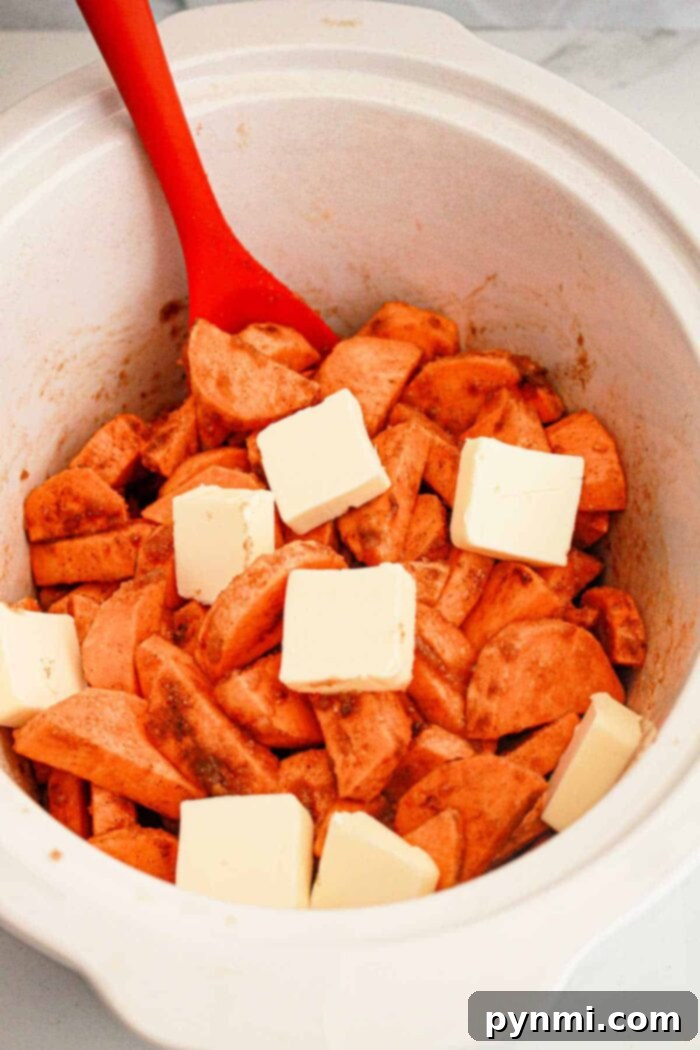 Crock-Pot Caramelized Sweet Potato Delight 7 A serving of finished candied sweet potatoes in a Crockpot, showing the rich sauce and tender slices.