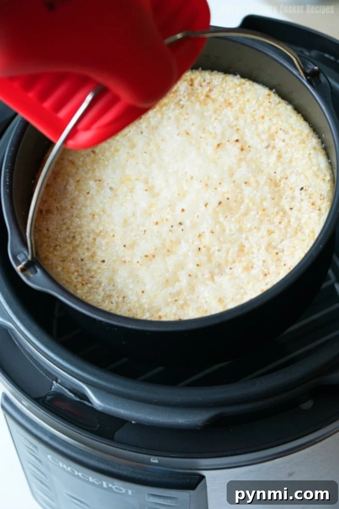Perfectly Cooked Crock Pot Express Grits A bowl of creamy, hot Crock Pot Express grits, garnished with green herbs, signifying a perfect meal.