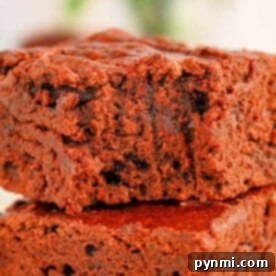 Close-up of two stacked black bean brownies made with brownie mix with a soft, crumbly texture, perfectly showcasing the rich mix of flavors.