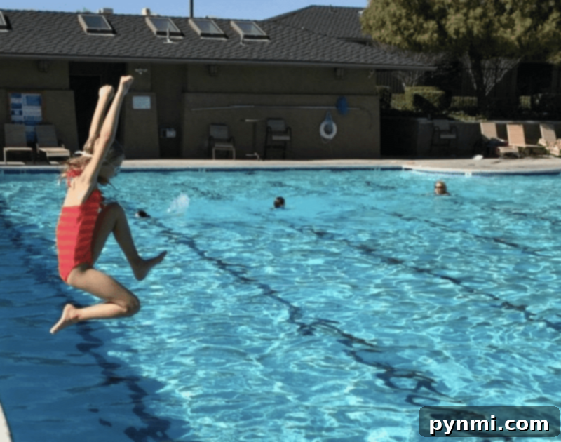 Thrifty Summer Adventures for Little Ones 4 children laughing and playing on a backyard water slide