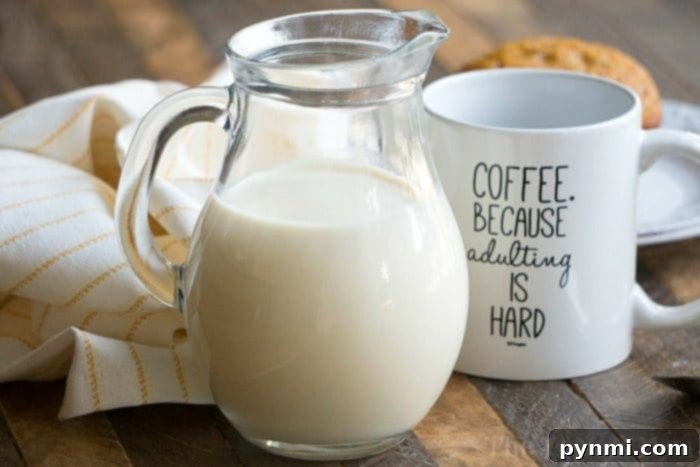 Pumpkin spice coffee creamer in a clear glass bottle, ready for fall coffee