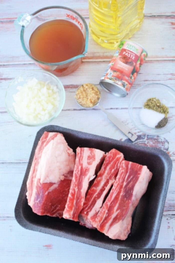 Ingredients for cooking: beef ribs, chopped onions, broth, tomato paste, minced garlic, spices, and oil on a table—perfect for a savory pressure cooker recipe.