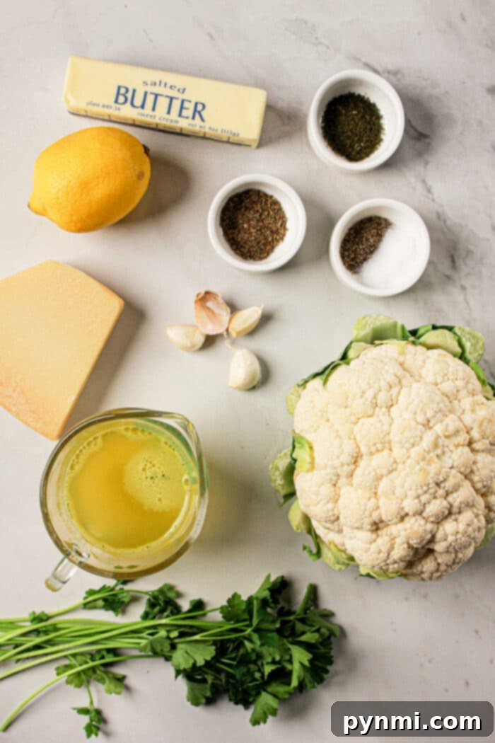 Perfectly Tender Whole Cauliflower Slow Cooker Edition 3 Ingredients on a marble surface: butter, lemon, cheese, garlic, whole cauliflower, herbs, broth in a jug, and small spice bowls. Perfect for creating a delightful cauliflower recipe that can easily be adapted for Crock Pot cooking.