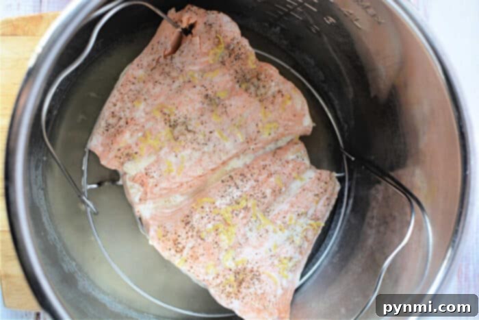 Tender Pressure Cooker Salmon in Minutes 6 Salmon fillets infused with pepper and lemon zest, cooked effortlessly in a pressure cooker.