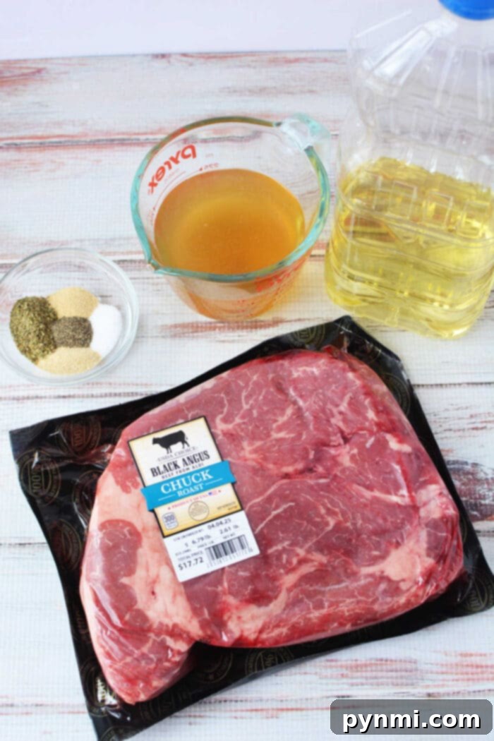 Ingredients on a table: boneless chuck roast, oil, broth in a measuring cup, and spices in a glass bowl.