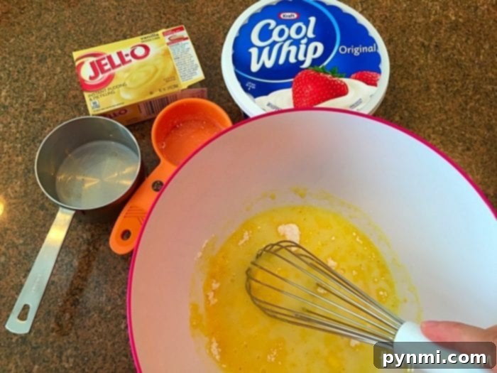 A rich, creamy Jell-O pudding frosting, perfectly swirled and ready to top your favorite cakes or desserts.