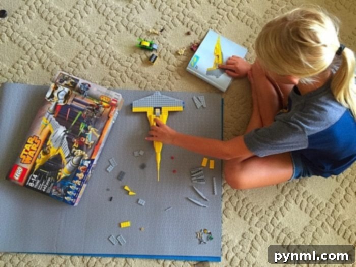 Father and daughters building a LEGO Star Wars set together