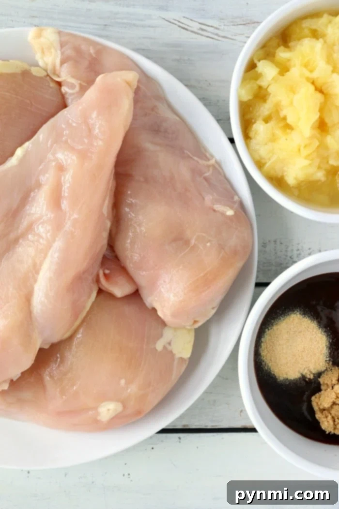 Delicious BBQ Crockpot shredded chicken, ready in a slow cooker. Slow cooker filled with Hawaiian BBQ chicken before shredding