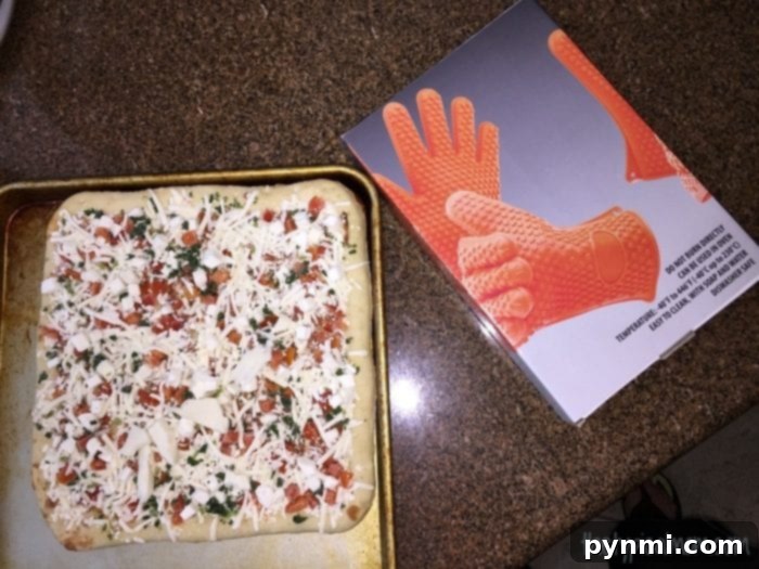 Outdoor Pizza Perfection: From Freezer to Grill 4 Placing a frozen pizza on an old cookie sheet, ready for grilling.